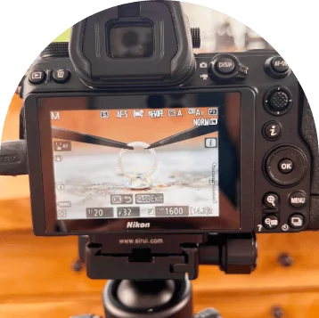 Rear view of a Nikon camera showing a close-up of soldering a silver ring.