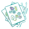 Drawing of jewelry designs on paper with paintbrushes beside them.