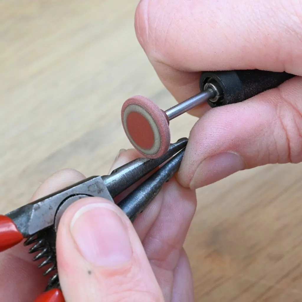 Modifying ring opening pliers with a rubber wheel for making paperclip link chain Modifying ring opening pliers with a rubber wheel for making paperclip link chain