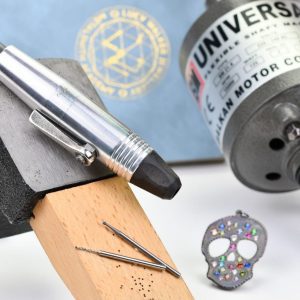 flex shaft drill for jewelry making with flush set pendant in back ground and drill bits for jewelry making in foreground flex shaft drill for jewelry making with flush set pendant in back ground and drill bits for jewelry making in foreground