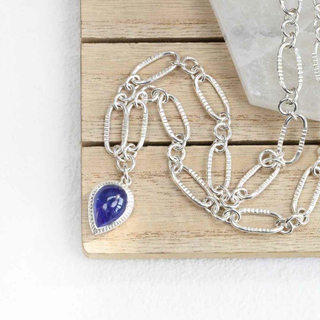 Handmade silver chain with bezel set tanzanite pendant