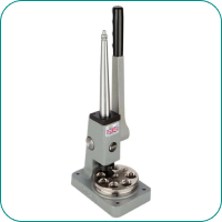 Hand press machine with a lever and multiple molds on a rectangular base.