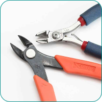 Two wire cutters with orange and blue grips on a white background.