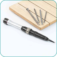 Close-up of a precision screwdriver with multiple bits placed on a wooden surface.