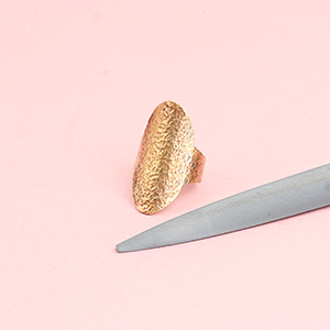 Half round hand file for jewelers and metalsmiths with a handmade bronze saddle ring