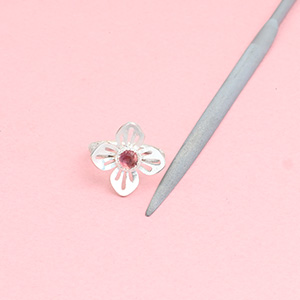 Half round needle file for jewelers and metalsmiths with handmade sterling silver flower ring with a tourmaline center stone Half round needle file for jewelers and metalsmiths with handmade sterling silver flower ring with a tourmaline center stone