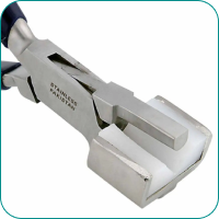 A metal crimping tool with a flat, rectangular jaw labeled "STAINLESS PAKISTAN.