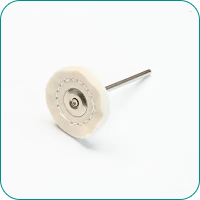 A rotary tool grinding attachment with a circular white buffing pad and a metal shaft.