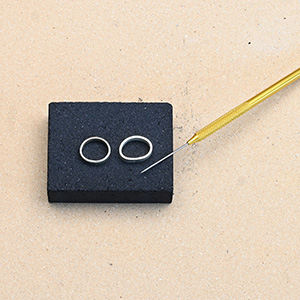 Charcoal block for soldering jewelry with solder pick and two rings ready for soldering Charcoal block for soldering jewelry with solder pick and two rings ready for soldering
