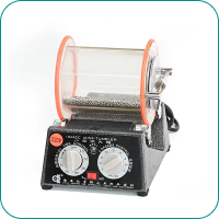 Rock tumbler with transparent drum and dual dials on the black unit base.