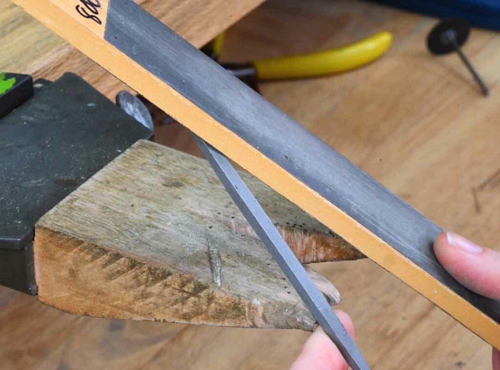 Using sandpaper to modify a file for jewelry making