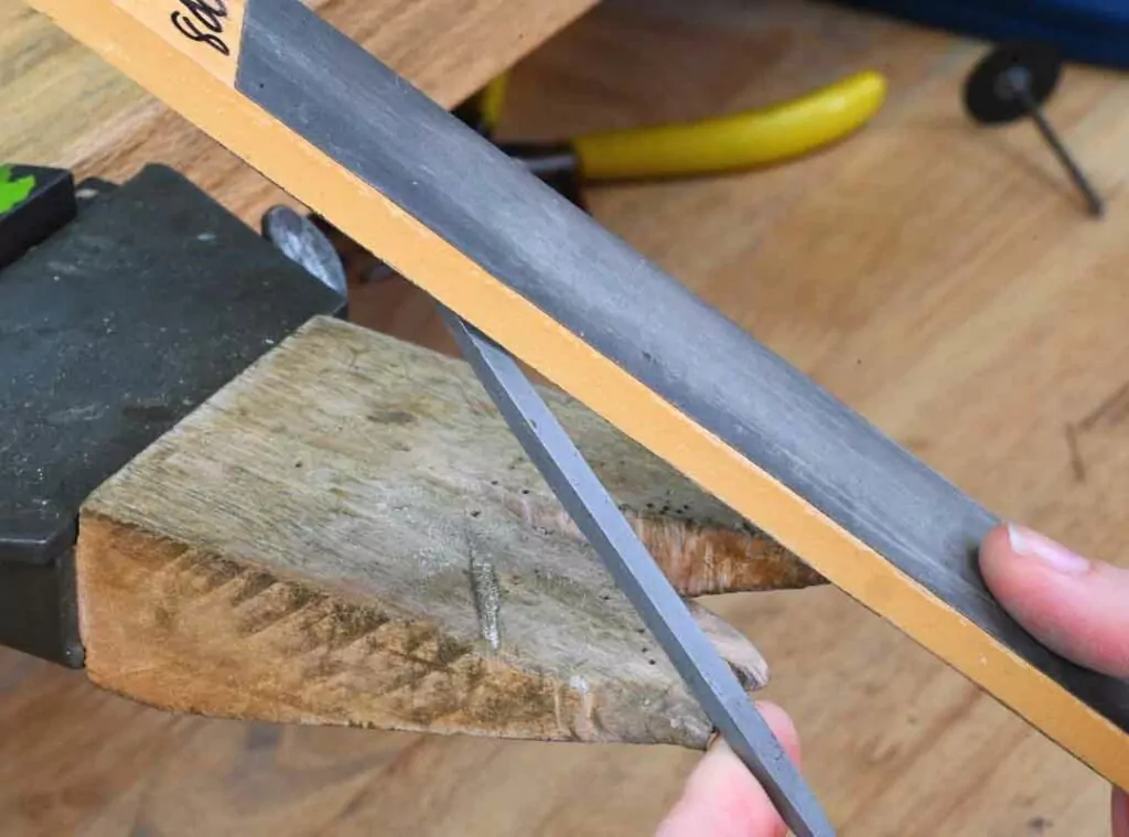 Using sandpaper to modify a file for jewelry making