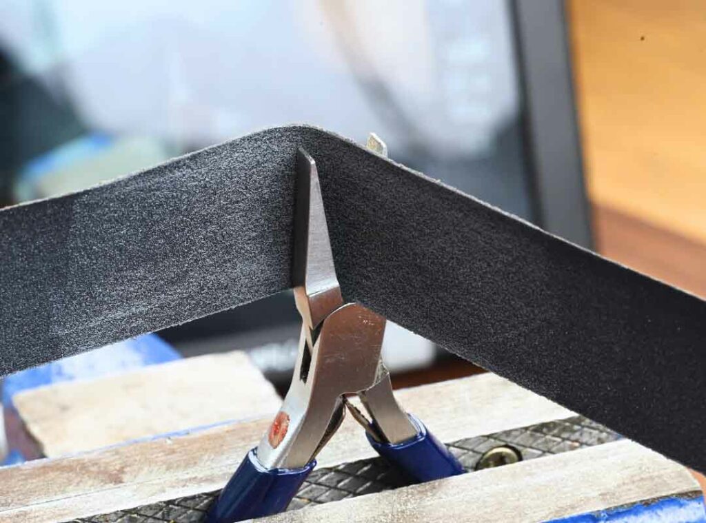 Using sandpaper to modify pliers for jewelry making