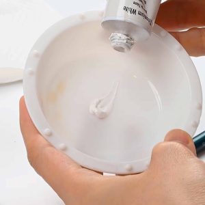 Mixing paint with paintbrush for rendering diamonds in jewelry design