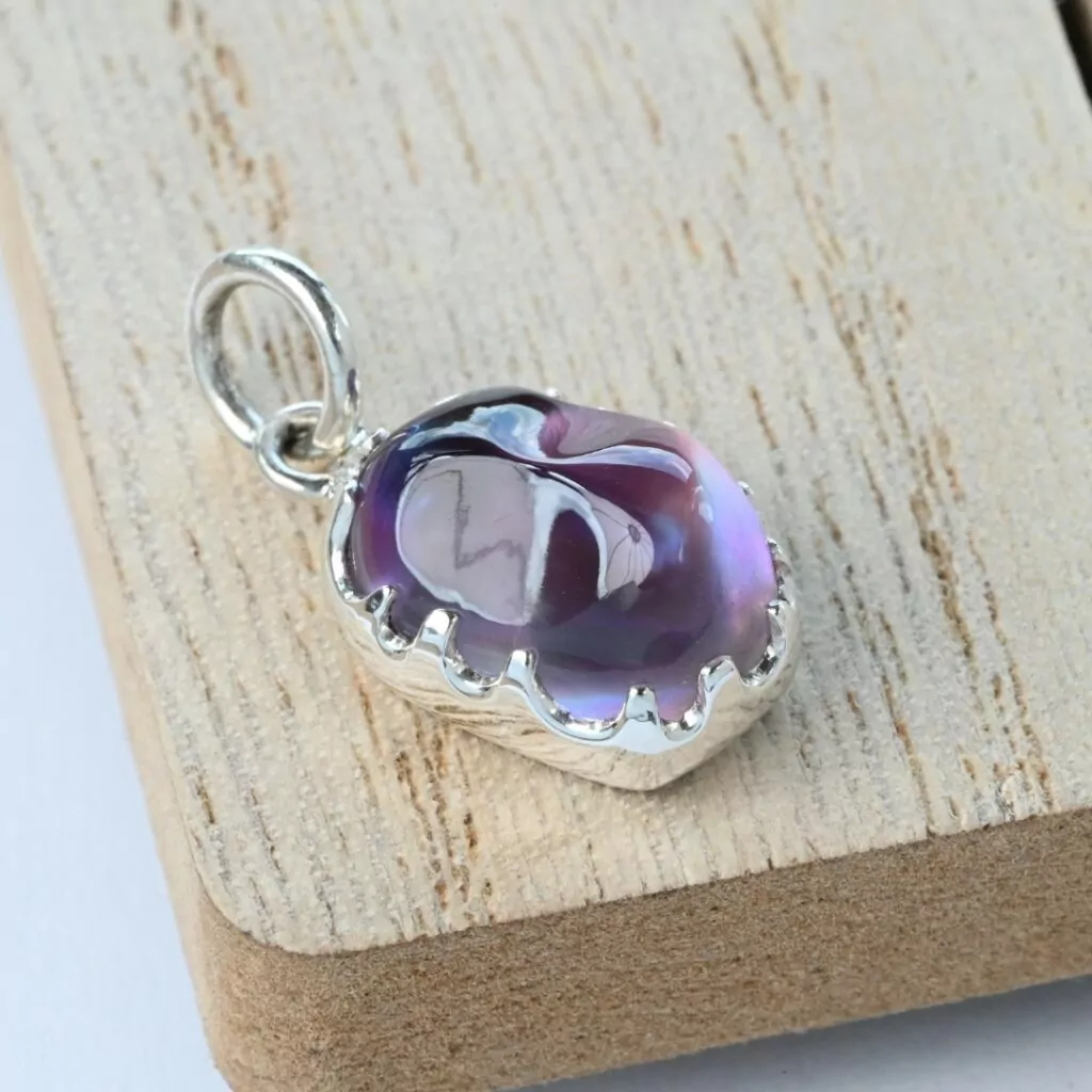 Amethyst irregular cabochon in a modified silver bezel
