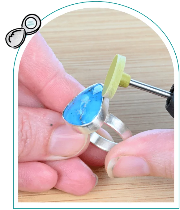 Person polishing a silver ring with a blue stone using a rotary tool.  From a guide on natural gemstones for jewelry making.